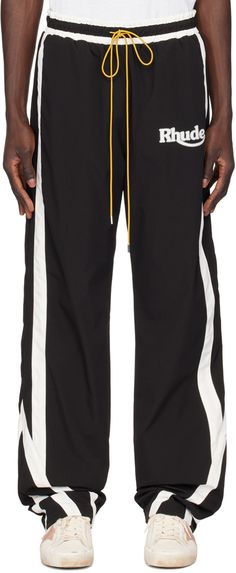 Crinkled polyester taffeta track pants. · Drawstring at elasticized waistband · Three-pocket styling · Logo printed at front · Stripes at outseams · Full twill lining Supplier color: Black/White Mens Track Pants, Track Pant, Mens Activewear, Drawstring Pants, Track Pants, Black Pants, Apparel Accessories, Skiing, Denim Jeans