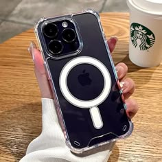 a woman holding up an iphone case with a magnifying glass on the back