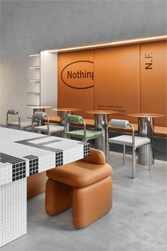 an orange and white booth with chairs and tables in the center, next to a sign that says nothing