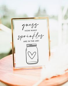 a card that says guess how many sprinkles are in the jar on a table