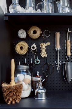 a shelf filled with lots of crafting supplies and tools on top of each other