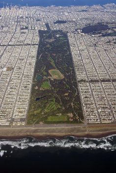 an aerial view of a large city with lots of land and water in the foreground