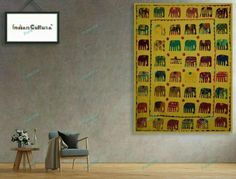 an elephant themed wall hanging in a living room next to a chair and coffee table