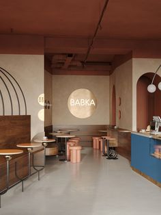 the interior of a restaurant with tables and stools