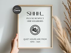 a person holding up a poster with the words shift please respect our neighbors quiet hours are from 11pm - 7am