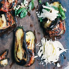 grilled eggplant and artichokes on a cutting board with parmesan cheese