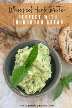 a bowl filled with guacamole next to bread