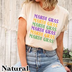 a woman wearing a t - shirt that says mardi gras