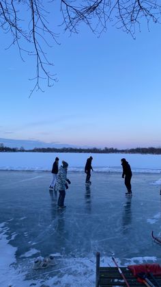 several people are standing on an icy lake