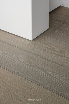 a white box sitting on top of a wooden floor