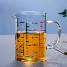 a measuring cup filled with liquid on top of a table