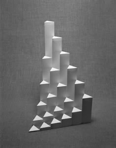 a sculpture made out of white cubes on a gray background