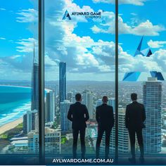 three men standing in front of a window looking out at the ocean and skyscrapers