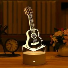 a guitar shaped lamp sitting on top of a table