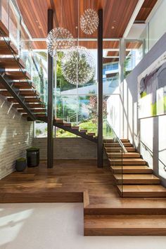 the inside of a modern house with wooden stairs