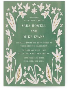 a green wedding card with white flowers and leaves on the front, in an ornate frame