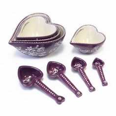 a set of purple plastic kitchen utensils and spoons in a bowl with beaded trim