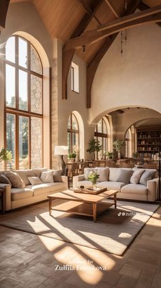 a living room filled with lots of furniture next to large windows on the side of a wall