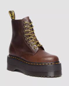 Created to be worn at full capacity, this outstanding revision of the classic 8-eye configuration is complemented with our highest Quad Max sole. The upper is constructed from the strong, supple Classic Pull Up leather, which will become more unique with time. Accompanied with antique gold eyelets and either black or giraffe laces, the design is finalized with signature Dr. Martens touches such as a black and yellow heel loop and yellow welt stitching. Born on 01.04.60. Named the 1460 boot. Over Brown Dr Martens, Platform Doc Martens, Leather Platform Boots, Black Platform Shoes, Yellow Heels, Dr Martens Boots, Boots Uk, Tripp Nyc, Black Platform