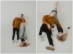 two people laying on the ground with their arms around each other and one person holding his head