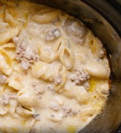 a crock pot filled with pasta and meat