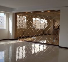 an empty living room with large windows and white tile flooring on the ground, in front of a mirrored wall