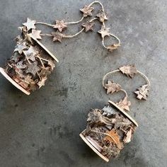 two pieces of metal with leaves on them sitting on the ground next to each other