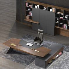 an office desk with a chair and bookshelf in front of the bookcase