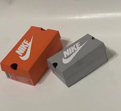 two boxes with nike logos on them sitting next to each other