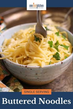 a bowl full of noodles with a fork in it and the words, single serving buttered noodles