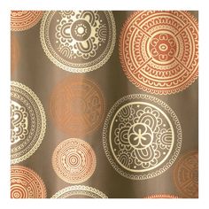 a brown and gold shower curtain with circular designs on the bottom, in front of a white background