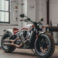 a motorcycle parked inside of a building next to a window