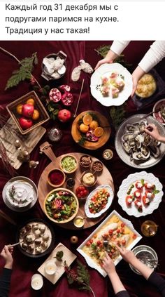 people sitting at a table with food on it and one person holding a plate in the middle