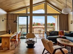 a living room filled with furniture and large windows