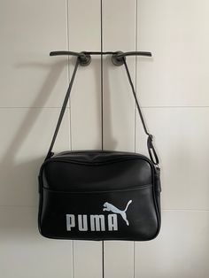 Thanks for visiting Beats and Treats. You are viewing a 1970's Puma Sports bag finished in Black vinyl with white Logo lettering. If you look at the "M" on the logo , the two indents on the top age this bag from the mid to late 70's. The later Logo from the 80's had a straight too to the M. In general terms the bag has aged really well, the zip and strap are fully working , it is very clean inside and out . The inner cardboard base is fully intact , the foor studs are all secure. There are no ri Puma Sport, Sports Bags Gym, Sports Gym, Gym Bags, Sport Gym, Team Sports, Black Vinyl, Sport Bag, The 80's