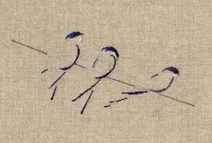 three small birds sitting on top of a piece of cloth next to eachother