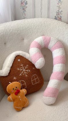 a gingerbread house with a candy cane on the chair