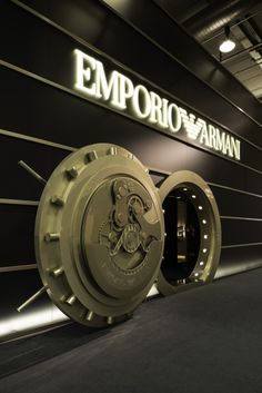 the entrance to an emporio farman showroom is shown in gold and black