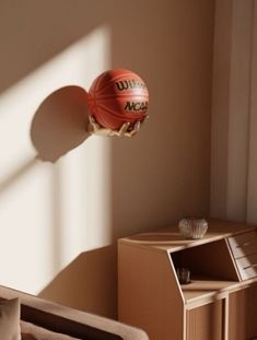 a basketball is flying through the air over a bed