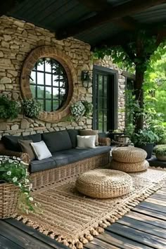 an outdoor living area with wicker furniture and round mirrors on the wall, along with potted plants