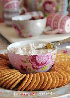 crackers and cottage cheese in a bowl on a floral plate with pink flowered china