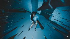 a woman sitting on a chair in the middle of a room filled with mirrors and lights