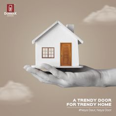 a hand holding a small white house on top of it's palm with the words, a trendy door for trendy home