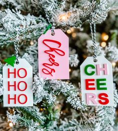 three christmas tags hanging from a tree