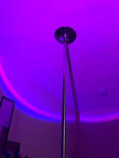 a purple light shines brightly on the ceiling