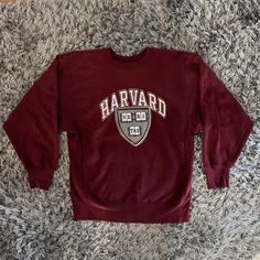 "Vintage Champion Harvard University Sweatshirt Size Large. Champion Tag. Maroon sweatshirt with front print. Front Print: \"Harvard\" with image of school crest. Some staining (shown in photos) THIS ITEM IS A VINTAGE / PRE-WORN PIECE SO SOME SIGNS OF NATURAL WEAR AND AGE ARE TO BE EXPECTED. 1150" Harvard University Uniform, Harvard Crewneck Outfit, Harvard Hoodie Aesthetic, Minimalist Athleisure, Harvard Merch, Harvard Sweater, Harvard Hoodie, Harvard Sweatshirt, Vintage Harvard Sweatshirt