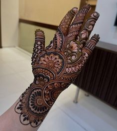 the hand is decorated with henna designs on it