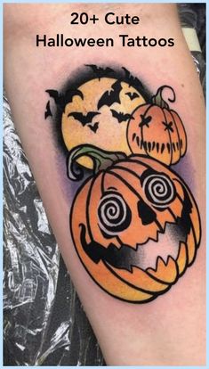 a tattoo with two pumpkins and bats on it