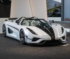 a white and black sports car is on display