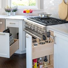 an open drawer in the middle of a kitchen